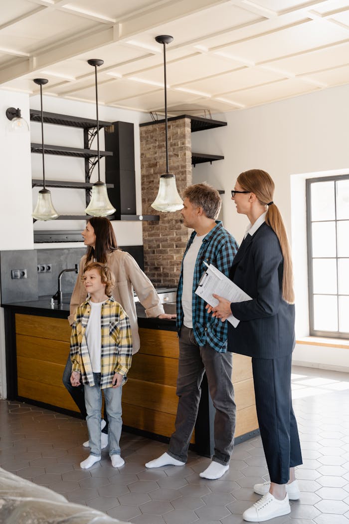 Family exploring a home with their real estate agent